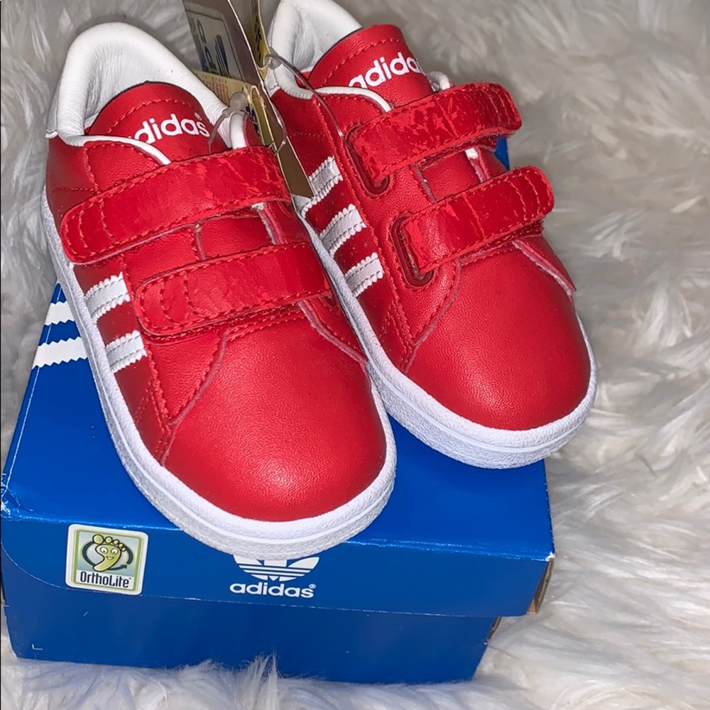 Red Adidas striped shoes